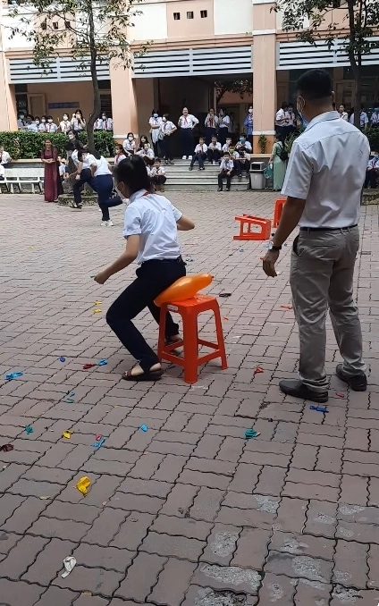 Các bé thiếu nhi hào hứng tham gia đập bóng bằng mông cho trẻ em trên sân cỏ trường học